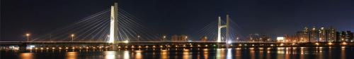 Dramatic panoramic city night scene of bridge